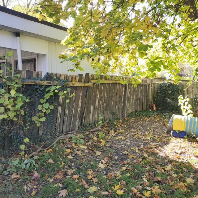 Back fence: old leaning fence before, new fence after (before) — Coghill Construction & Renovations
