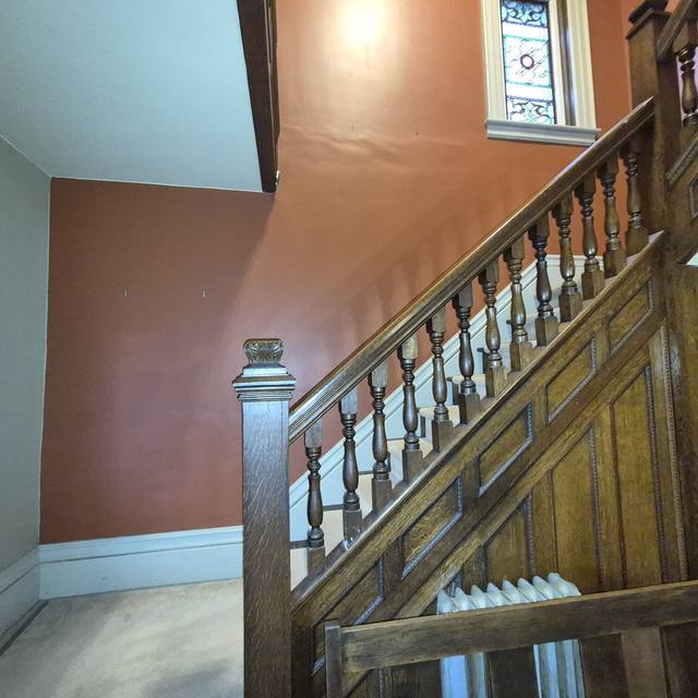 Stairwell: terracotta walls before, repainted after (before) — Coghill Construction & Renovations
