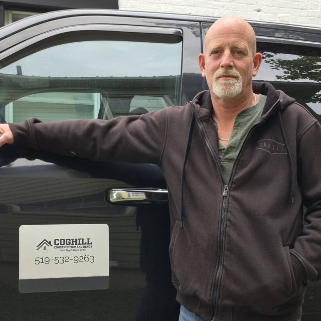 Jeff Coghill, owner of Coghill Construction & Renovations, beside his branded truck